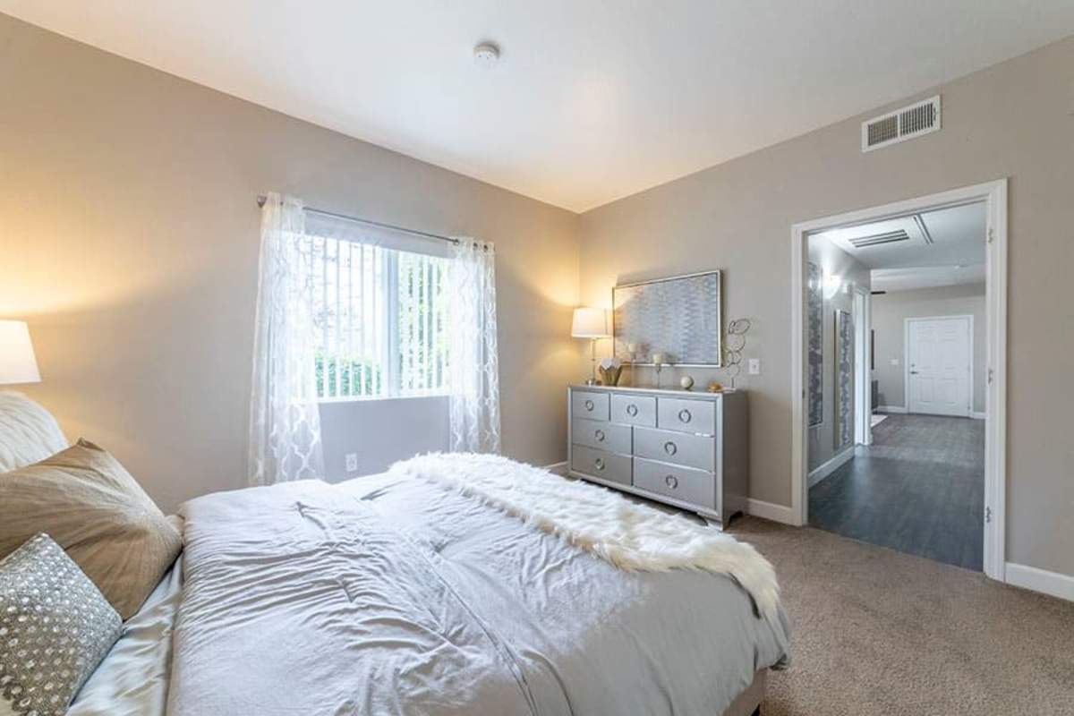 Bedroom with large window at Villas at D'Andrea Apartment Homes in Sparks, Nevada