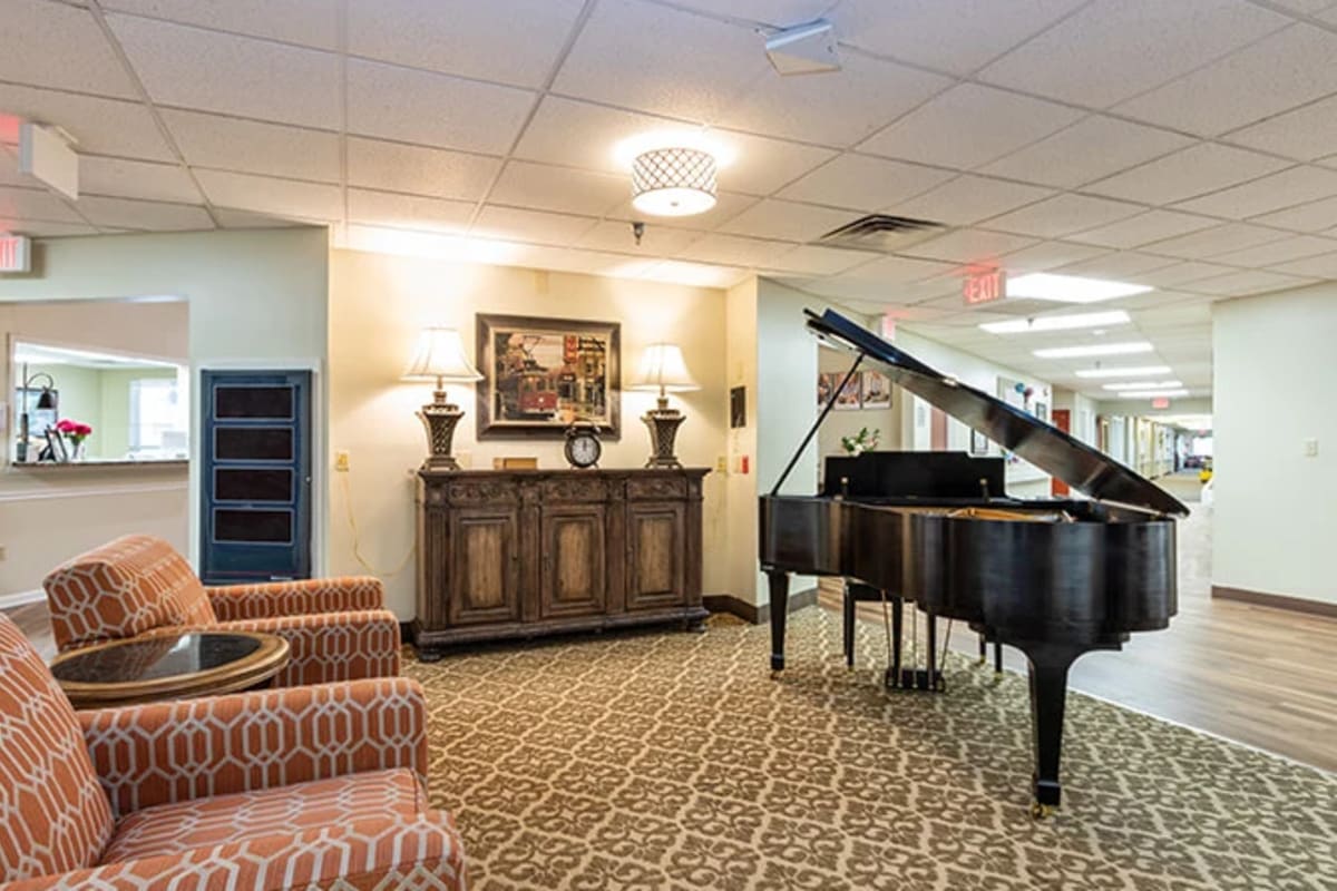 Community area with a piano at Trustwell Living at Shelby Gardens Place in Cordova, Tennessee