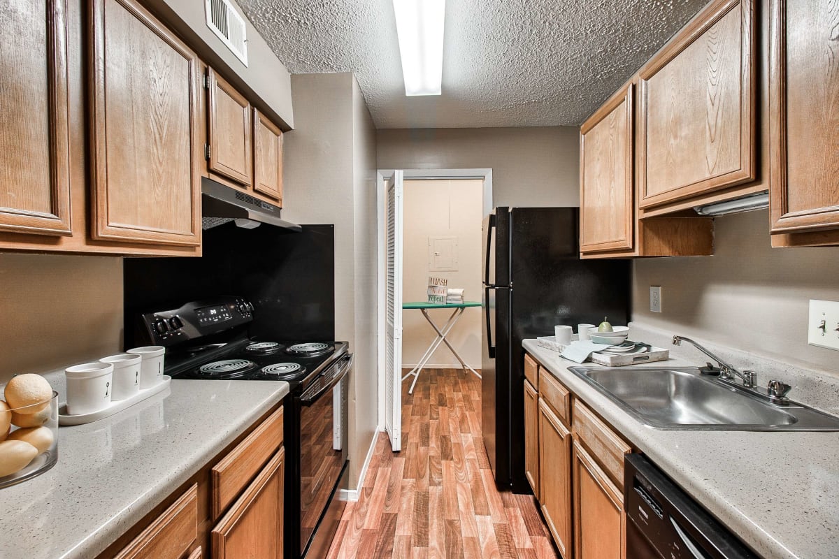 Resident kitchen with wood-style flooring at Knollwood in Mobile, Alabama