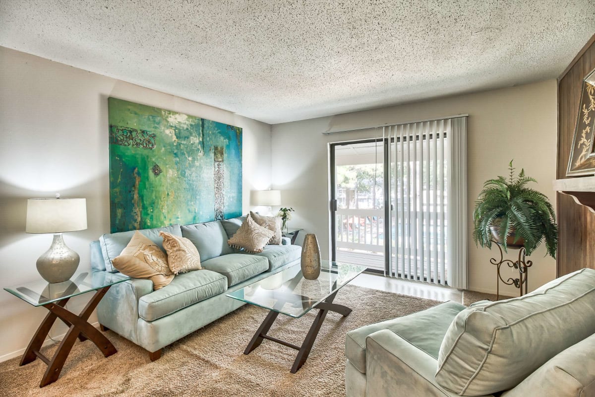 Resident living space with plush carpeting at Knollwood in Mobile, Alabama