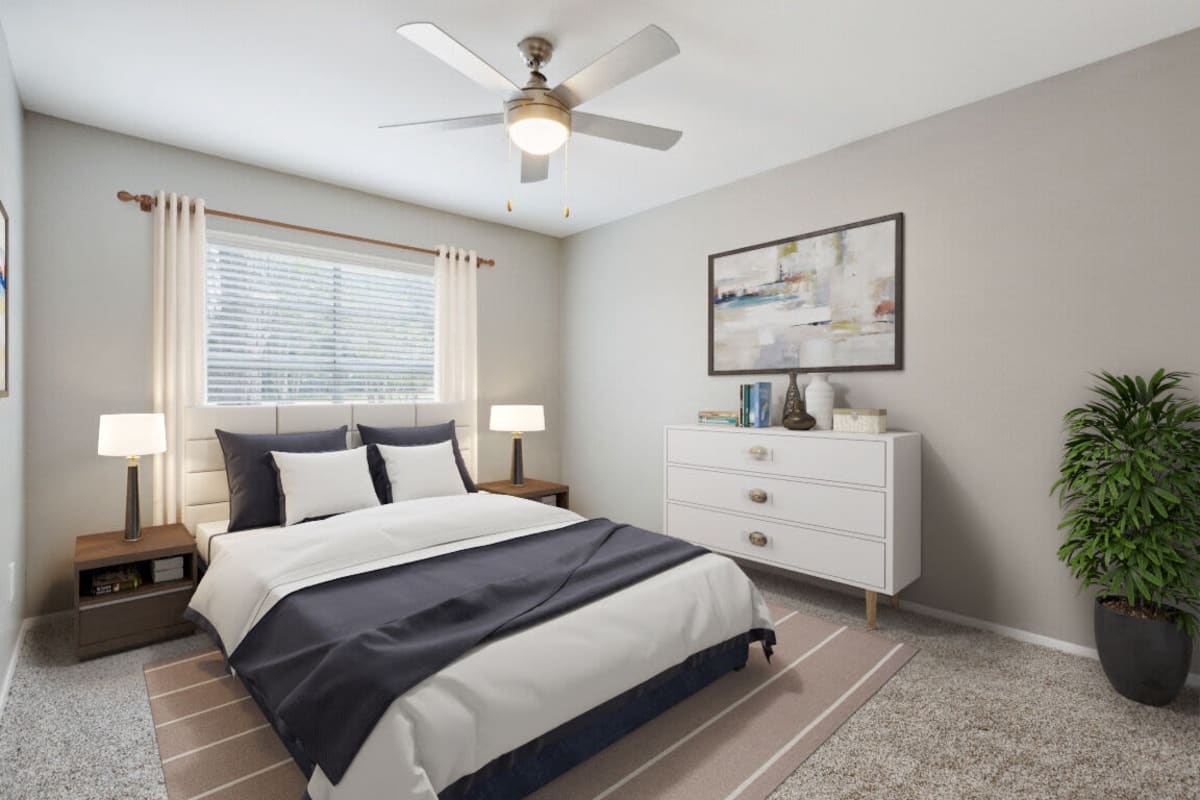 Master bedroom with a ceiling fan at The Park Apartments in Mobile, Alabama