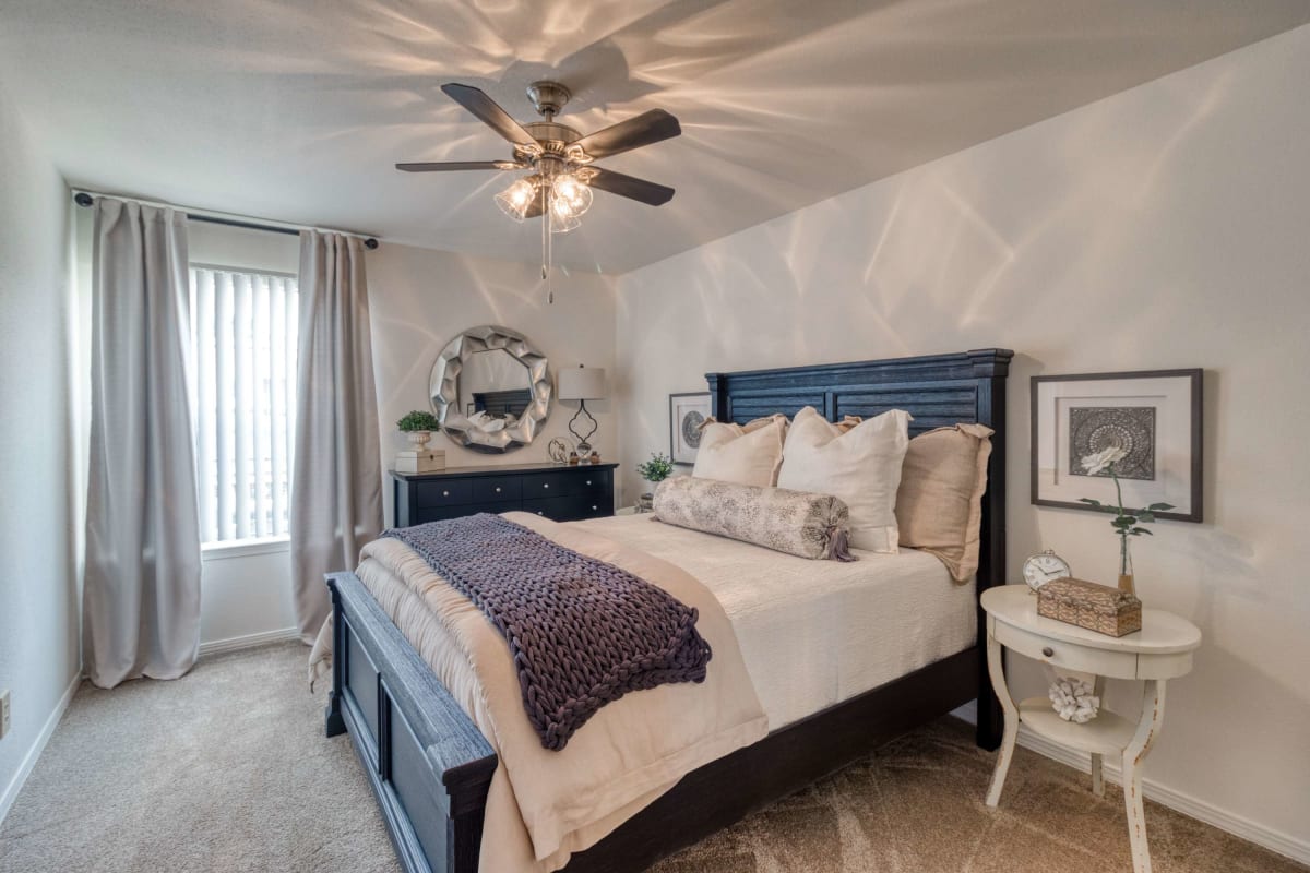 Resident master bedroom with a ceiling fan at Ashley Club in Pensacola, Florida