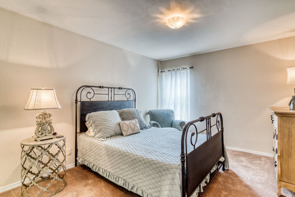Resident bedroom with plush carpeting at Courts at Waterford in Chattanooga, Tennessee