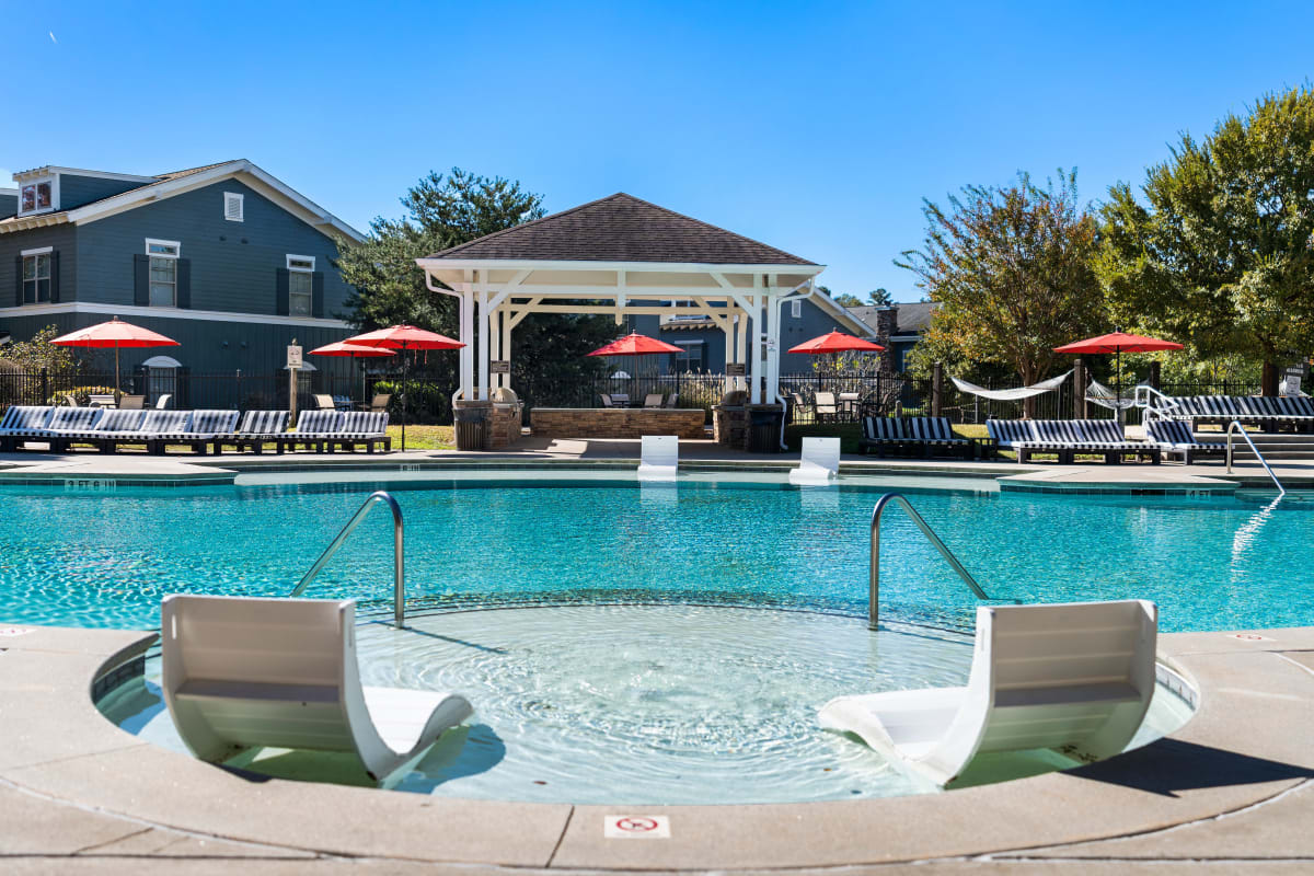 Resort style swimming pool with sun bathing area at West 22 in Kennesaw, Georgia