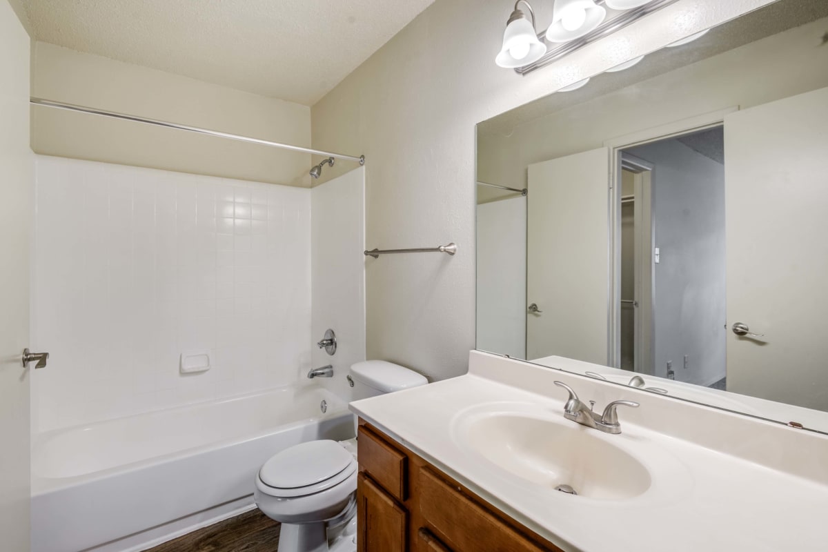 Bathroom with large vanity mirror and white countertop at The Views at Laurel Lakes in Laurel, Maryland