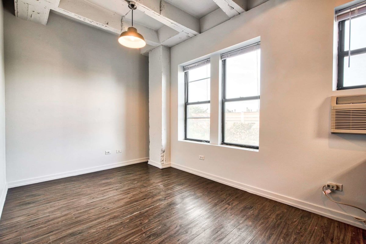 Resident open living space with wood-style flooring at The Maynard at 1325 W Wilson in Chicago, Illinois