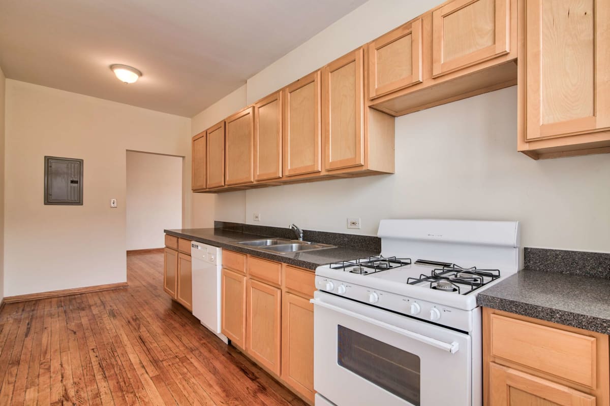 Kitchen with wood-style flooring at The Maynard at 7100 N Sheridan in Chicago, Illinois