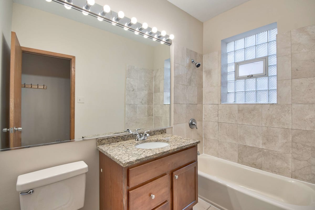 Resident bathroom with great lighting at The Maynard at 6351 N Lakewood in Chicago, Illinois