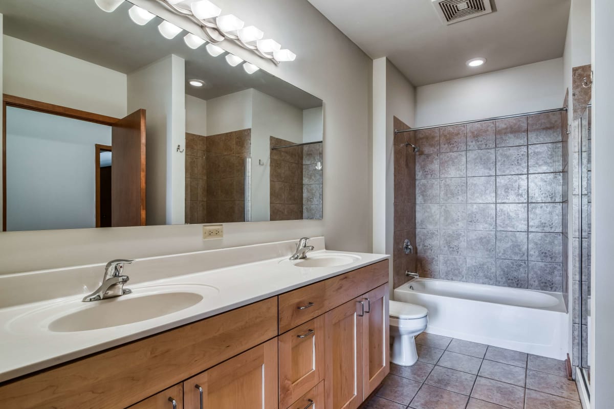 Resident bathroom with great lighting at The Maynard at 2934 N Milwaukee in Chicago, Illinois