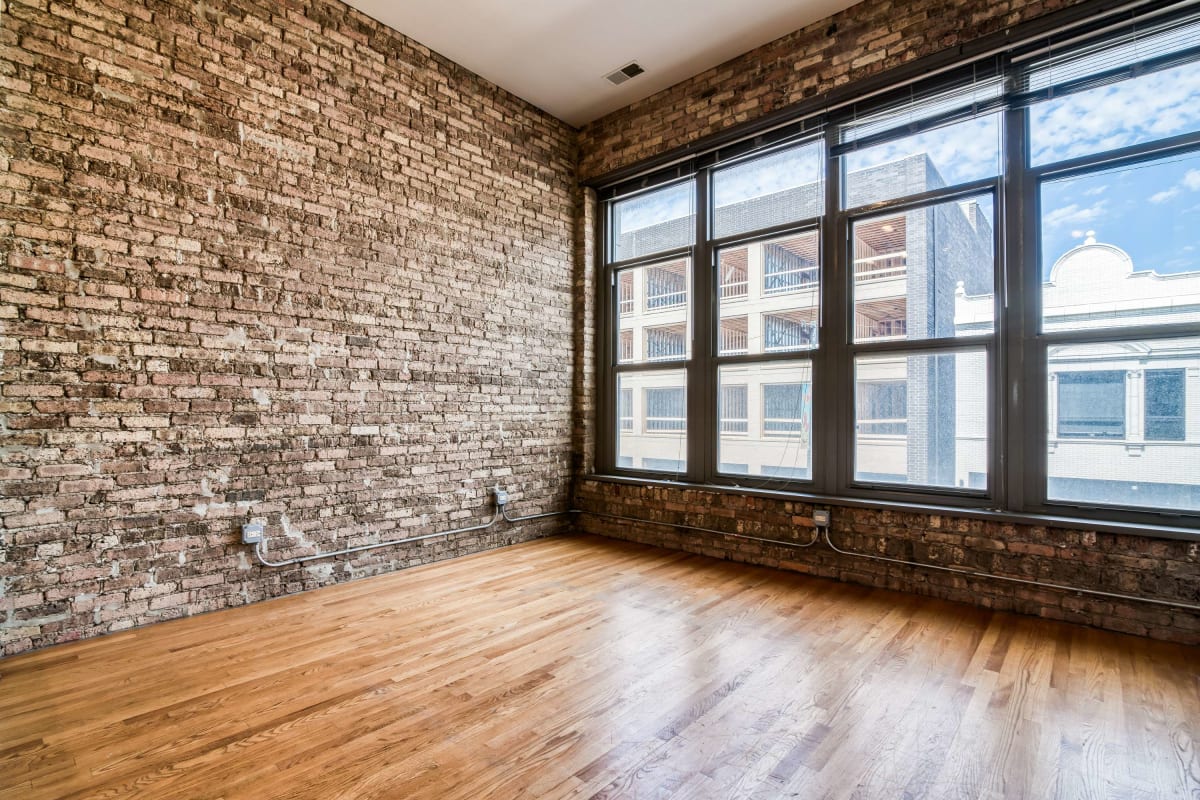Living space with wood-style flooring at The Maynard at 2934 N Milwaukee in Chicago, Illinois