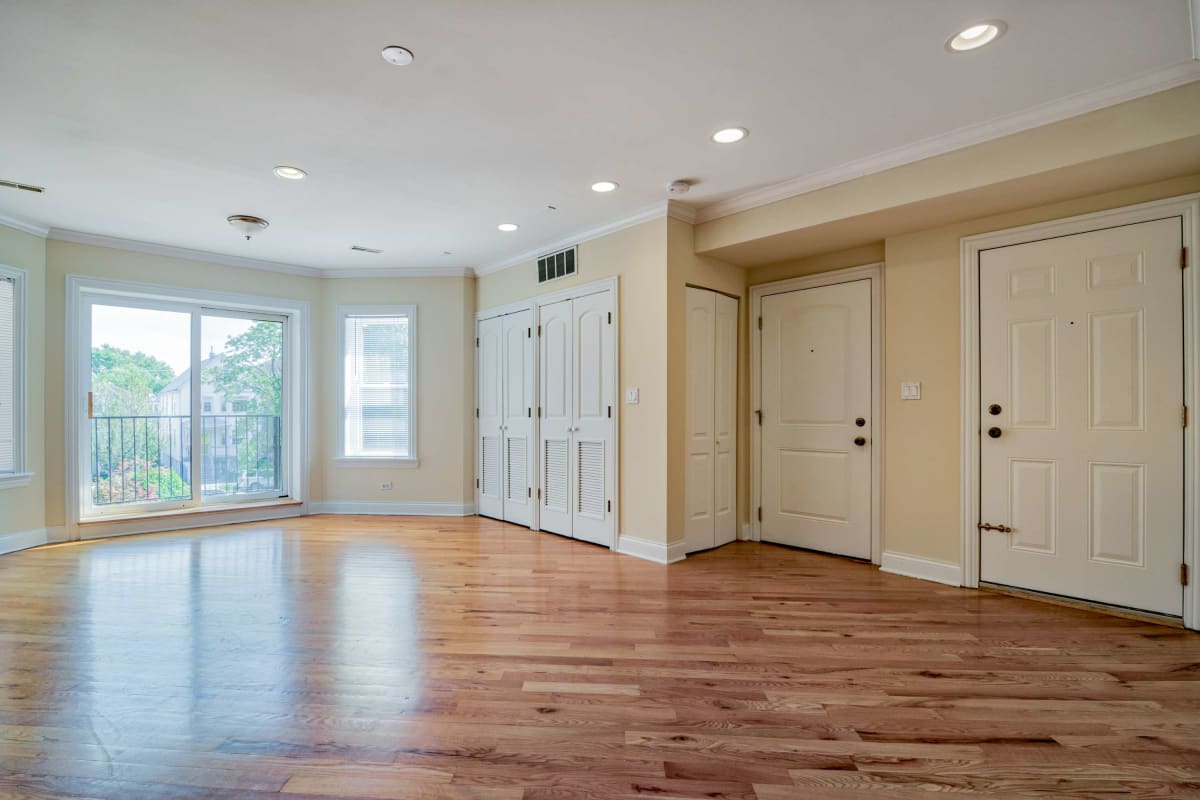 Large living space with wood-style flooring at The Maynard at 4014 N Central Park in Chicago, Illinois