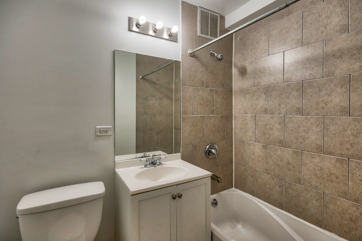 Resident bathroom with great lighting at The Maynard at 2529 W. Fitch in Chicago, Illinois