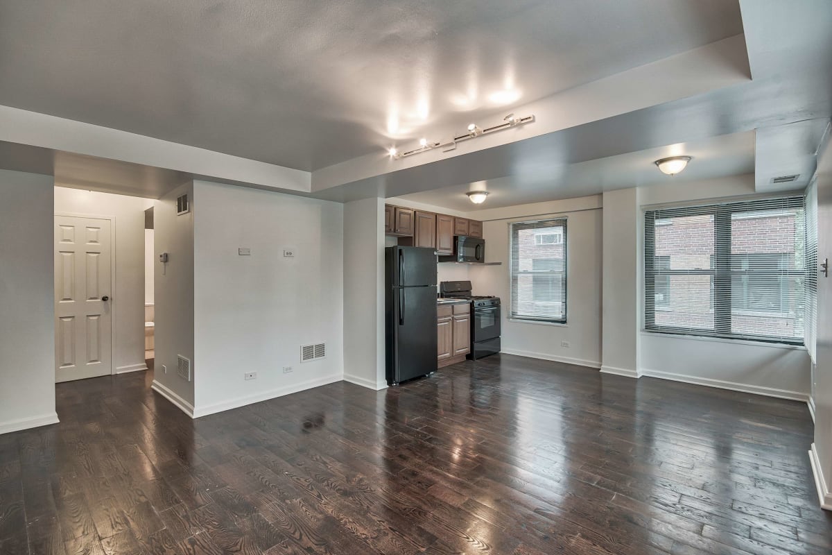 Resident living space with great wood-style flooring at The Maynard at 2529 W. Fitch in Chicago, Illinois