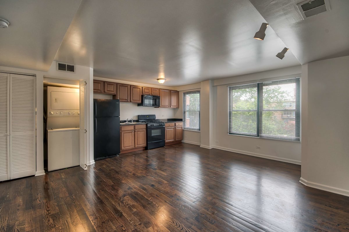 Open resident floor-plan with wood-style flooring at The Maynard at 2529 W. Fitch in Chicago, Illinois
