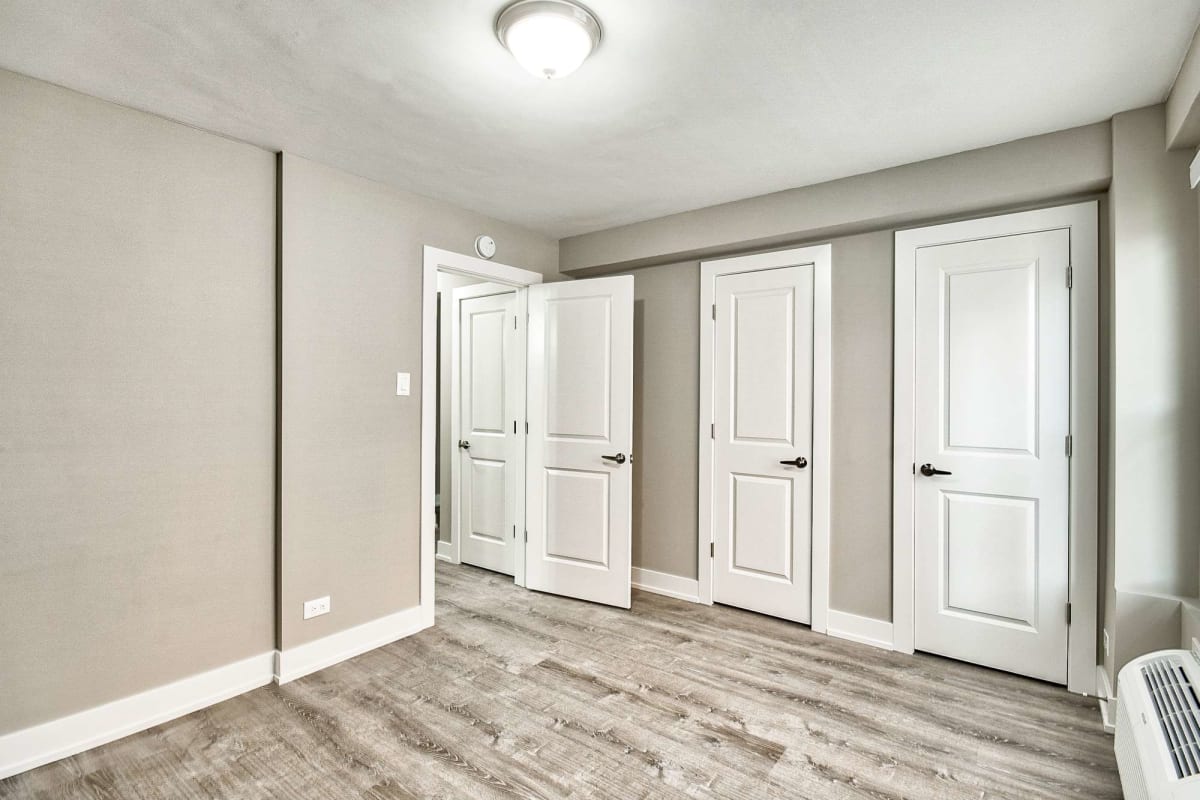 Empty bedroom with wood-style flooring at The Maynard at 2545 W Fitch in Chicago, Illinois