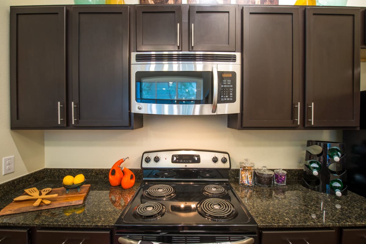 Full kitchen with stainless-steel appliances in a model student apartment at 33 North in Denton, Texas