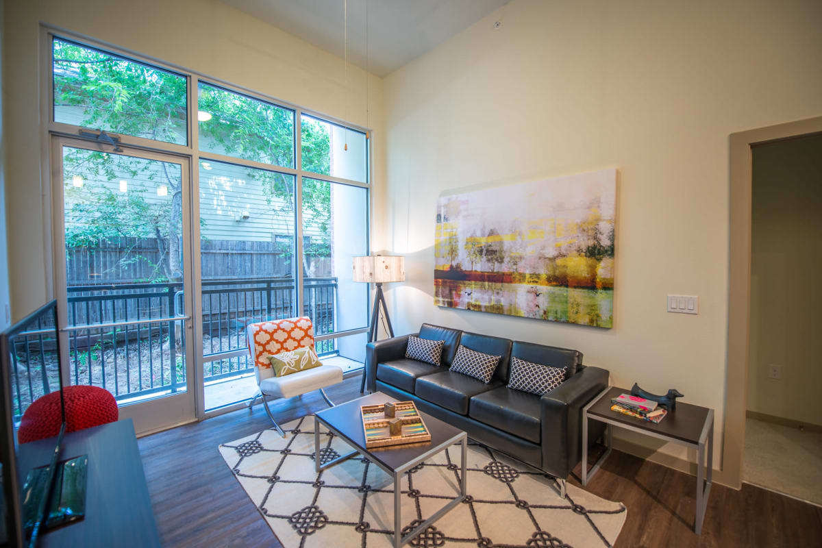 Well-decorated living space with an accent wall in a model student apartment at 33 North in Denton, Texas