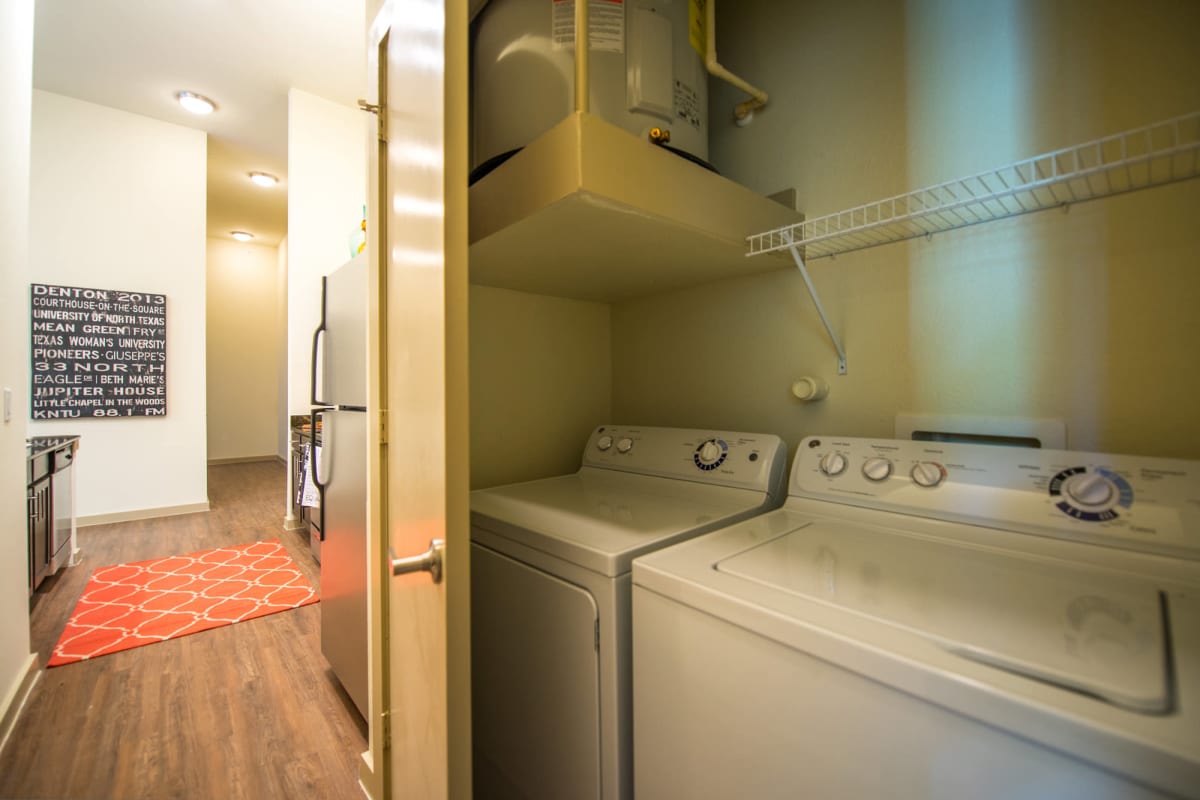 In-unit washer and dryer with extra linen storage at 33 North in Denton, Texas