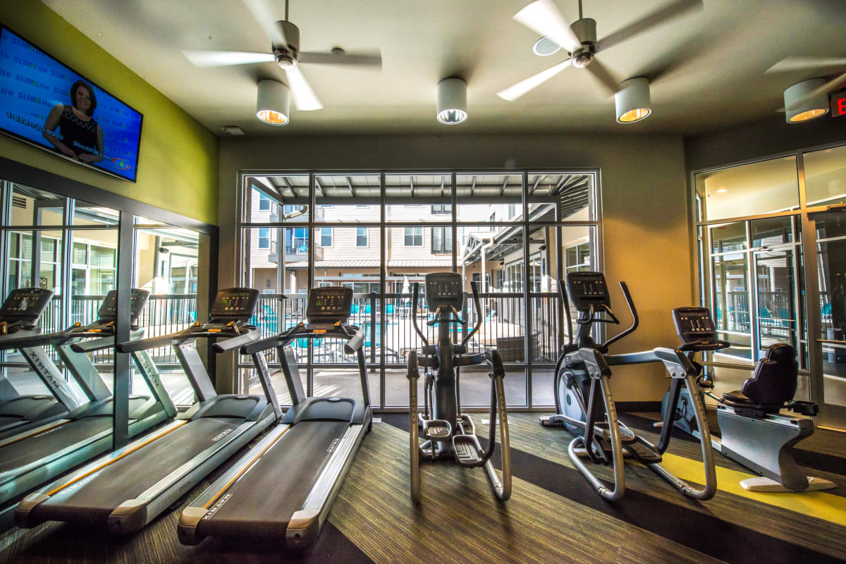 Modern gym fitness room with large windows and treadmills at 33 North in Denton, Texas
