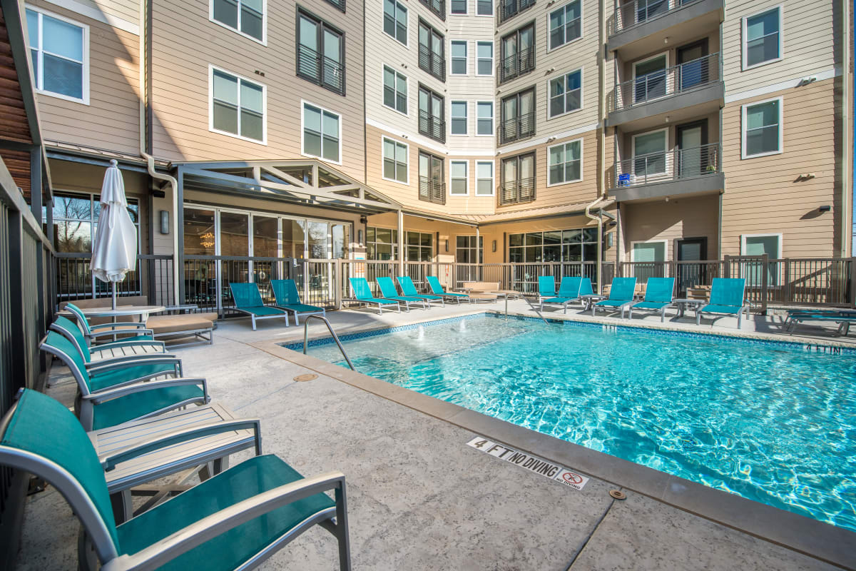 Deck chair around outdoor swimming pool at 33 North in Denton, Texas