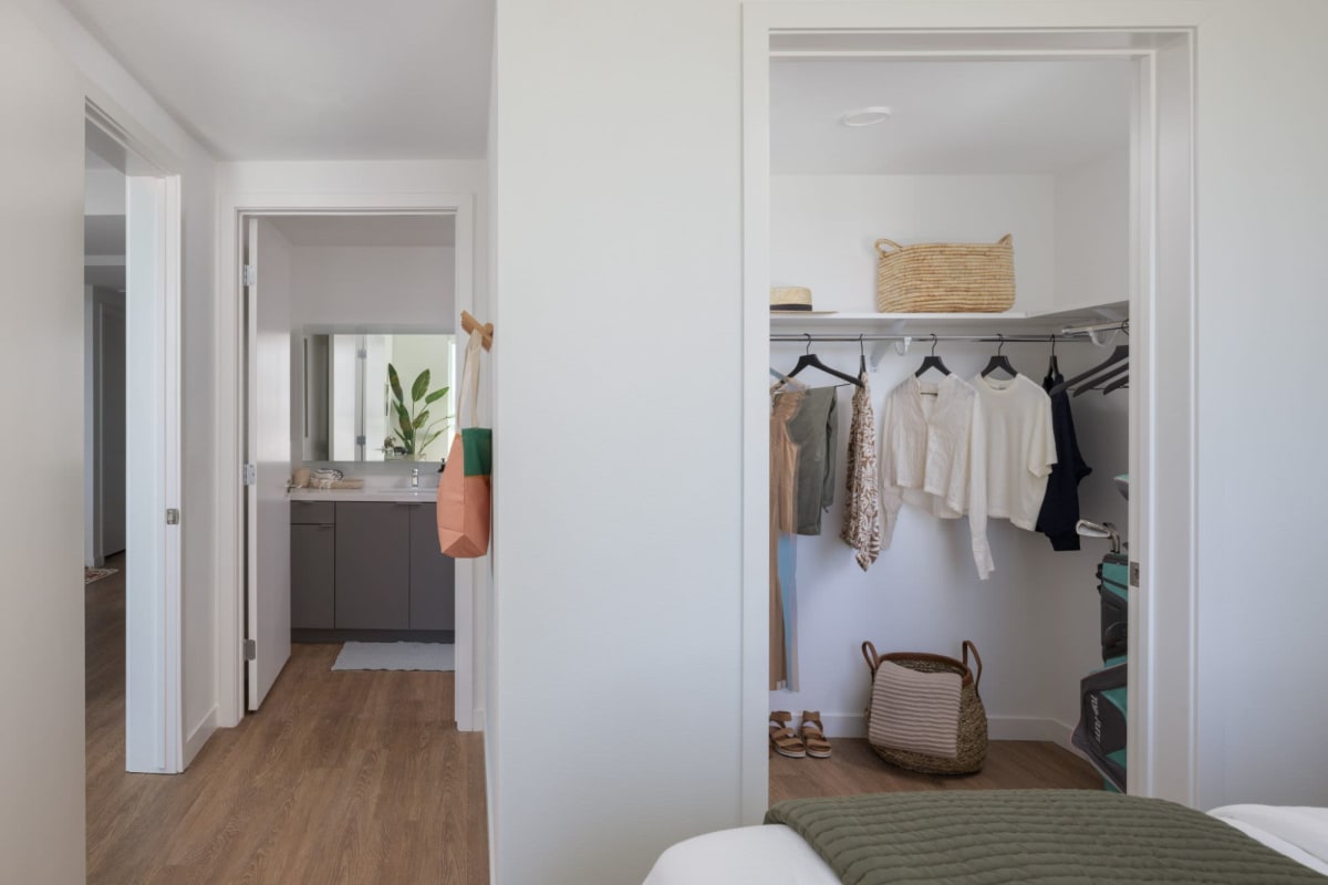 Master bedroom with closet and bathroom at Margo at the Society in San Diego, California