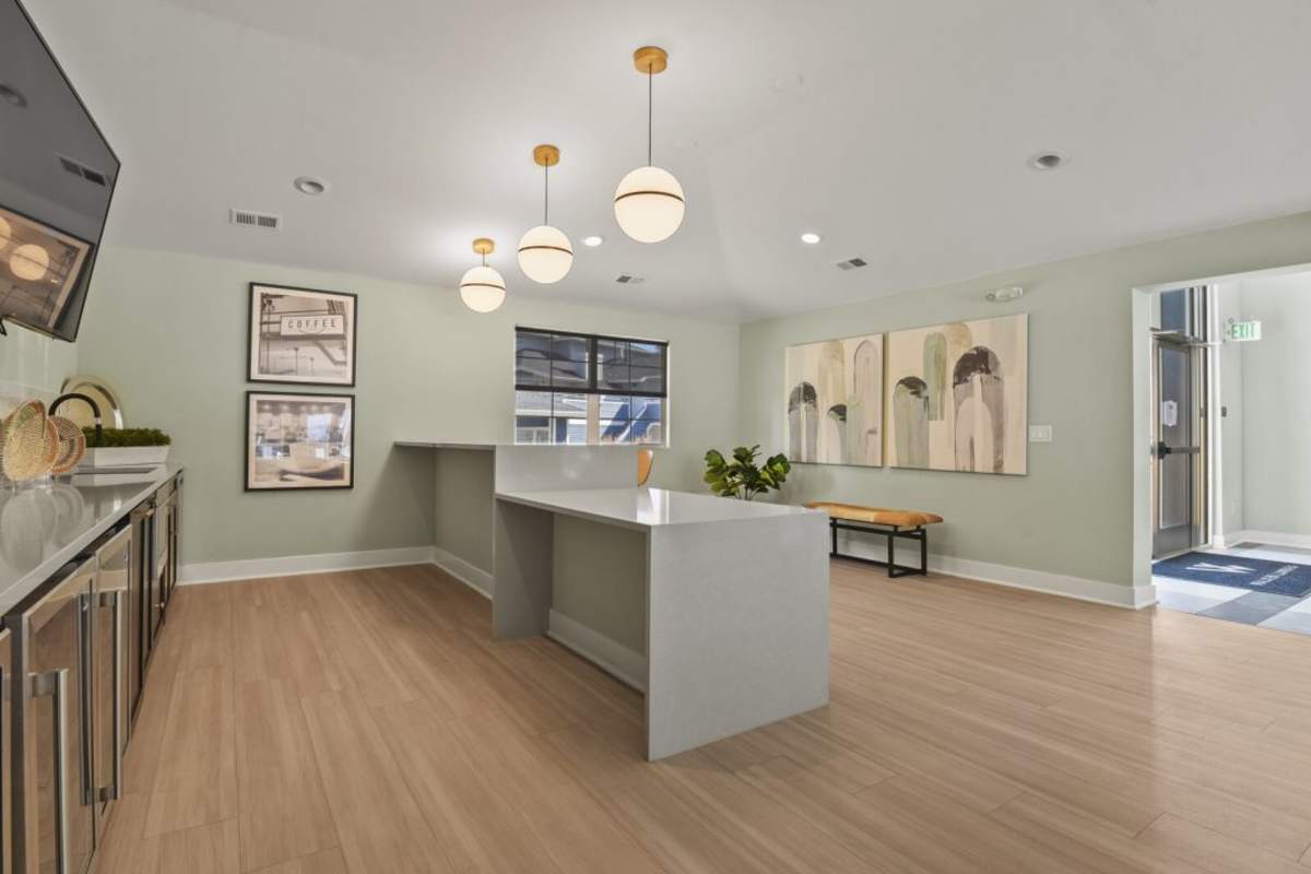 Community kitchen area in clubhouse with hard-wood style flooring at Walker Landing in Aurora, Colorado
