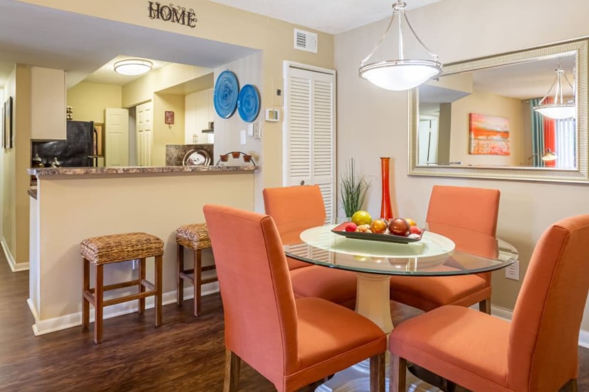 A dining table and chairs in a model apartment at Palmetto Place in Miami, Florida
