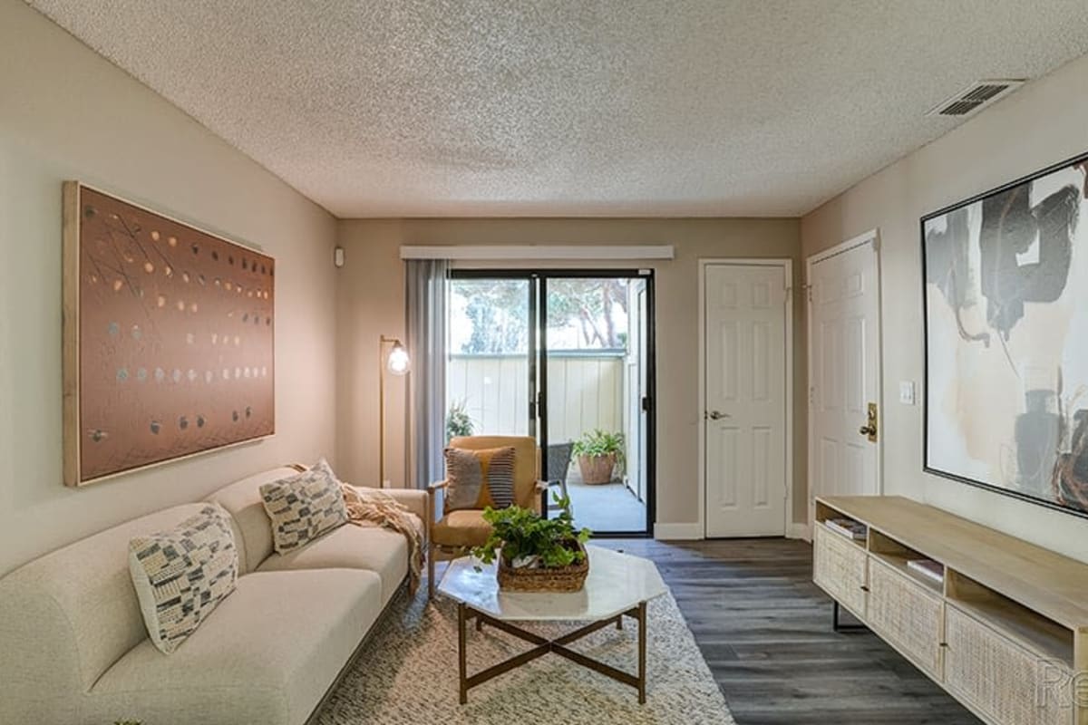 Living room filled with natural light at Austin Commons Apartments in Hayward, California