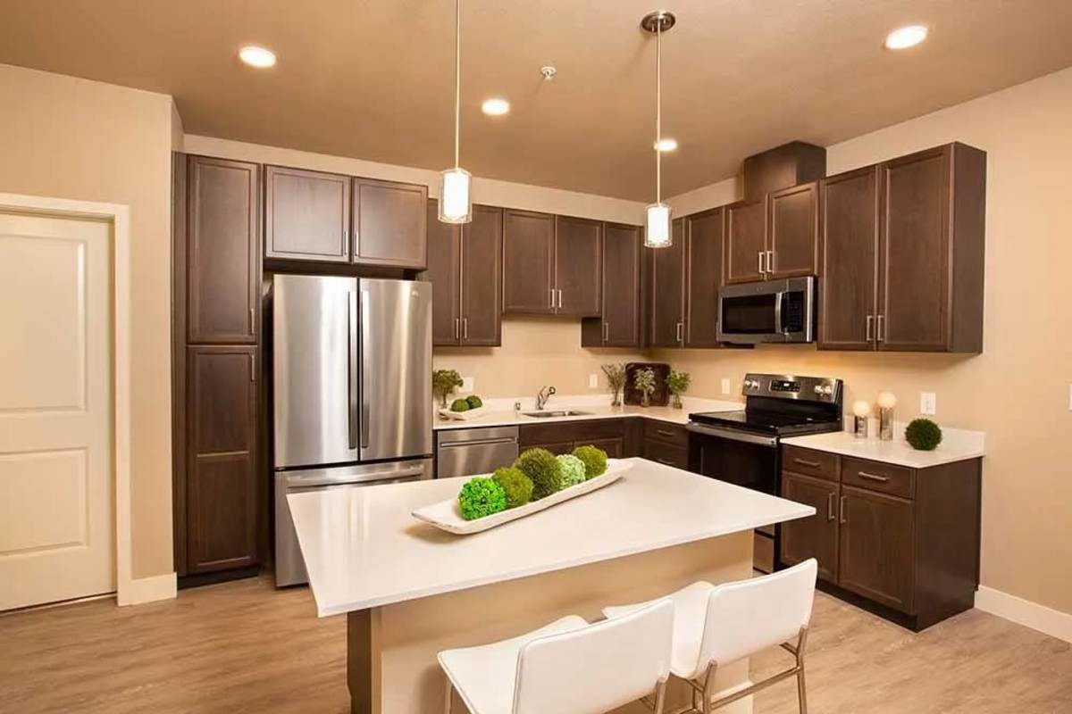 Sleek, modern kitchen with island seating at Allure Apartments in Modesto, California