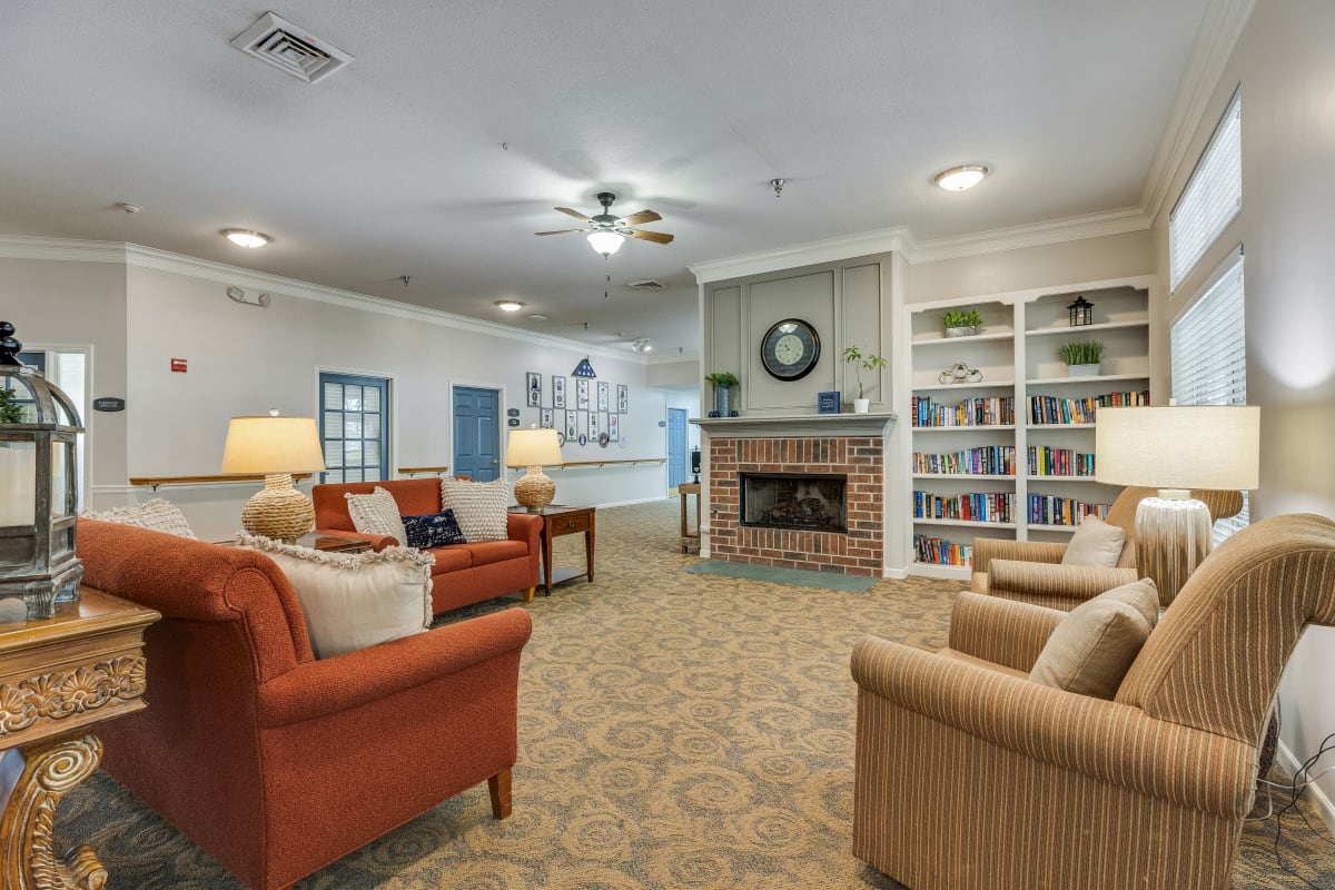 Comfortable seating around a fireplace at Village Cove Assisted Living in Hilton Head Island, South Carolina
