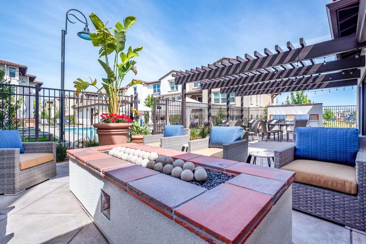 Outdoor lounge with fire pit at Ageno Apartments in Livermore, California