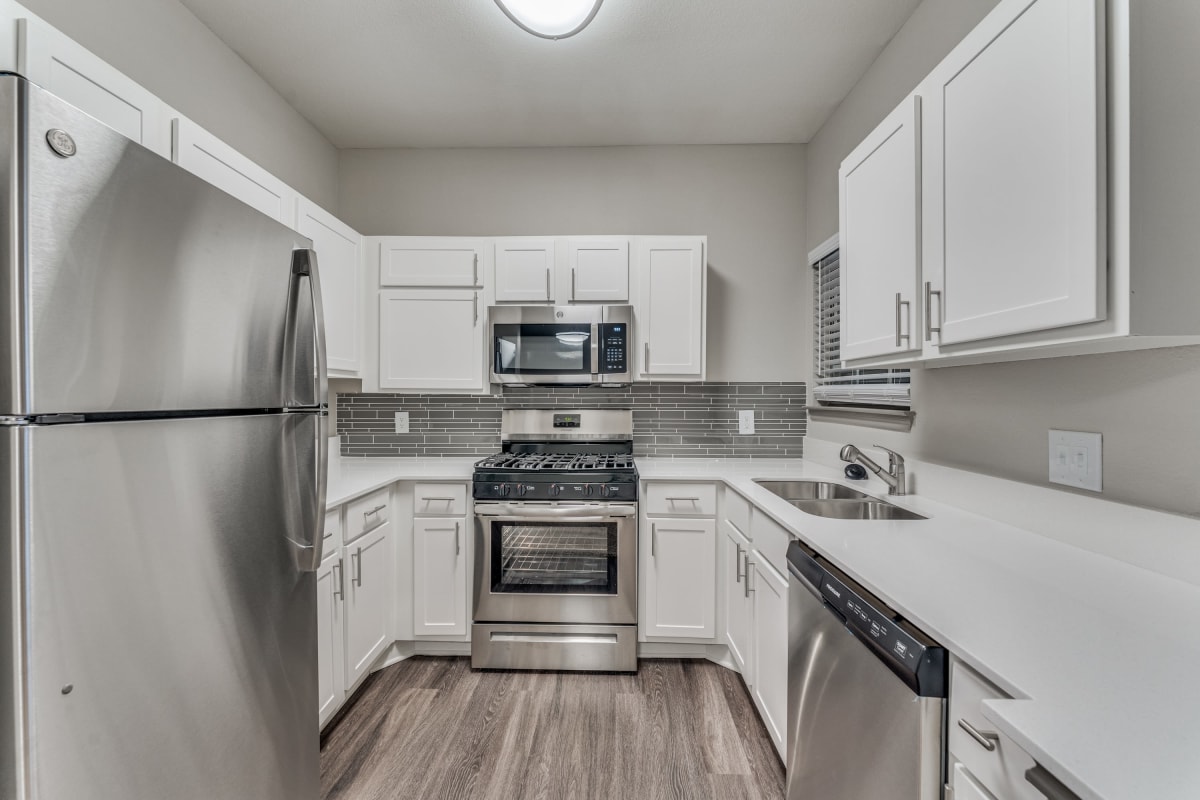 Stainless-steel appliances in an apartment kitchen at Parkside Crossing in Austin, Texas