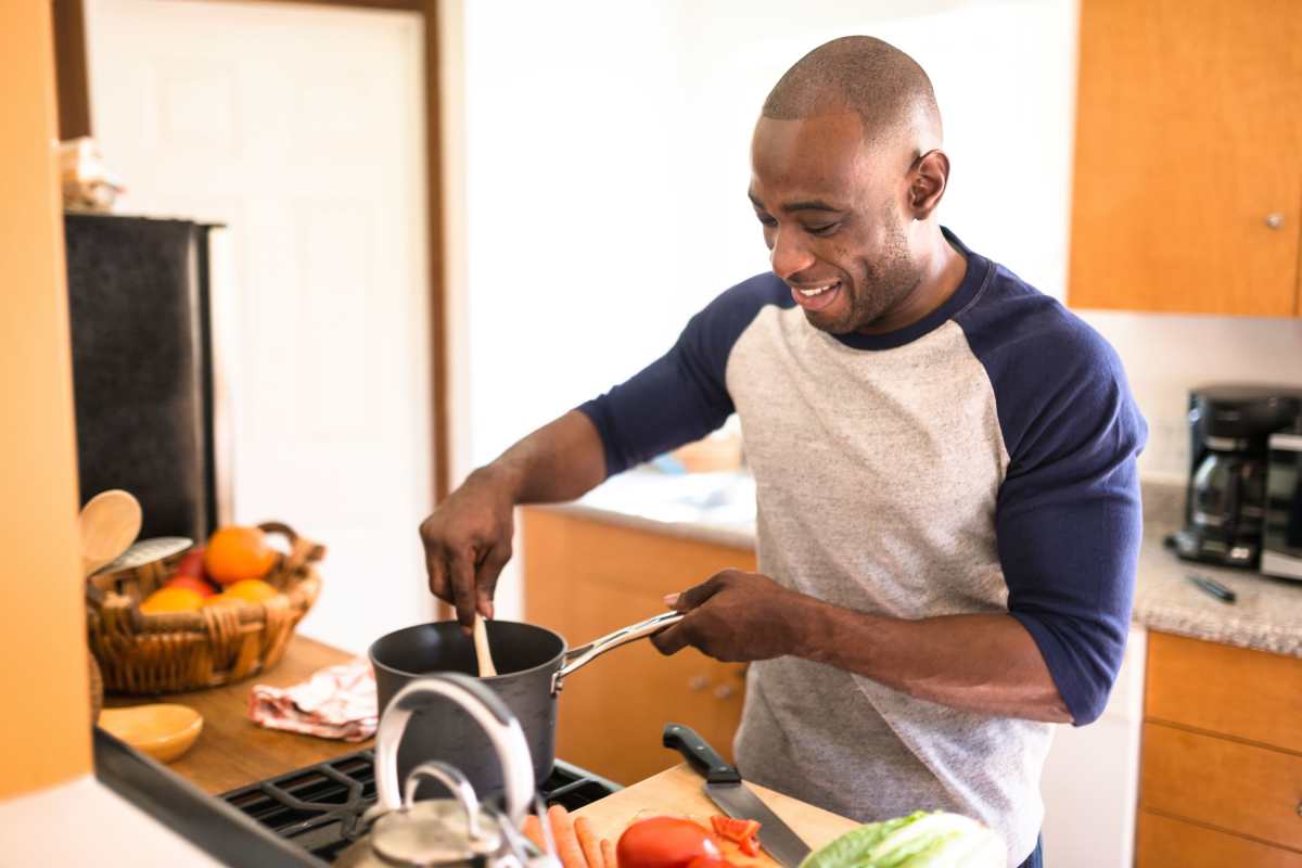 Resident cooking a meal in his new home at Topaz in San Diego, California