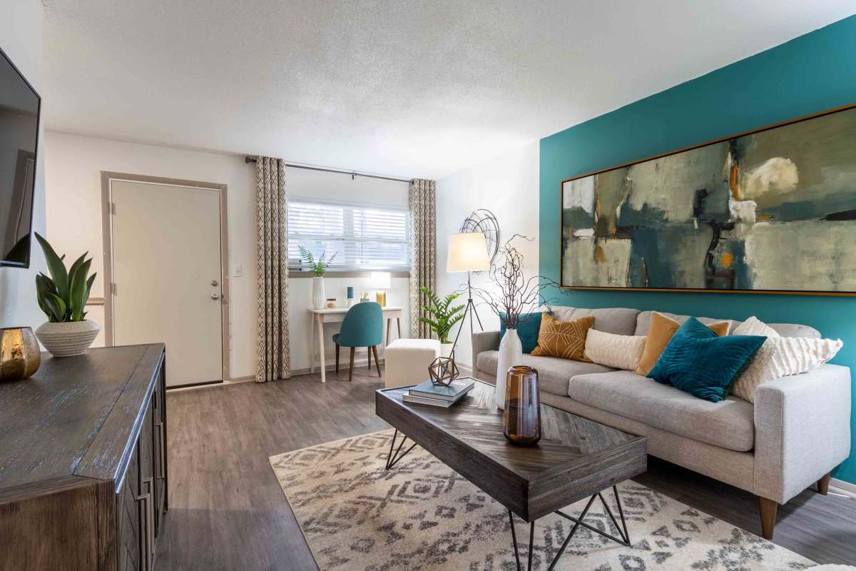 Living room with wood-style flooring at The Jaunt in Charleston, South Carolina