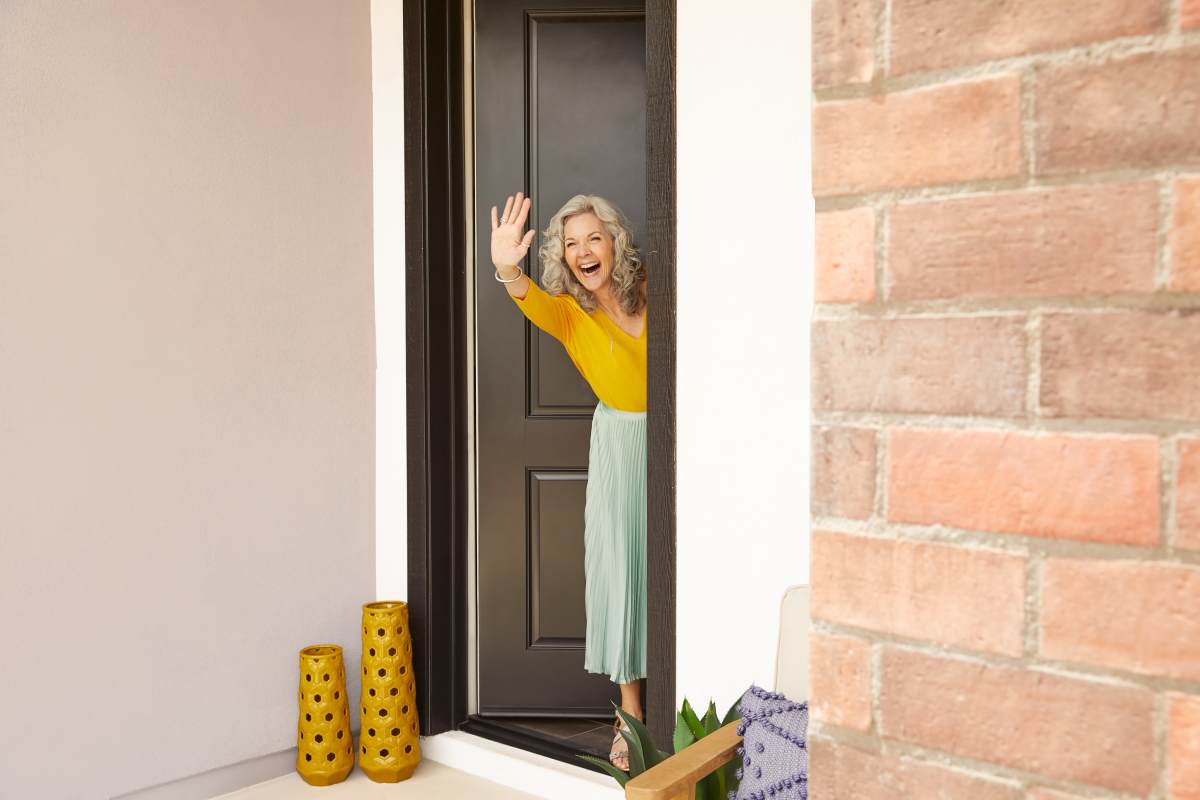 Resident waving to camera at BB Living Wellen Park in Venice, Florida