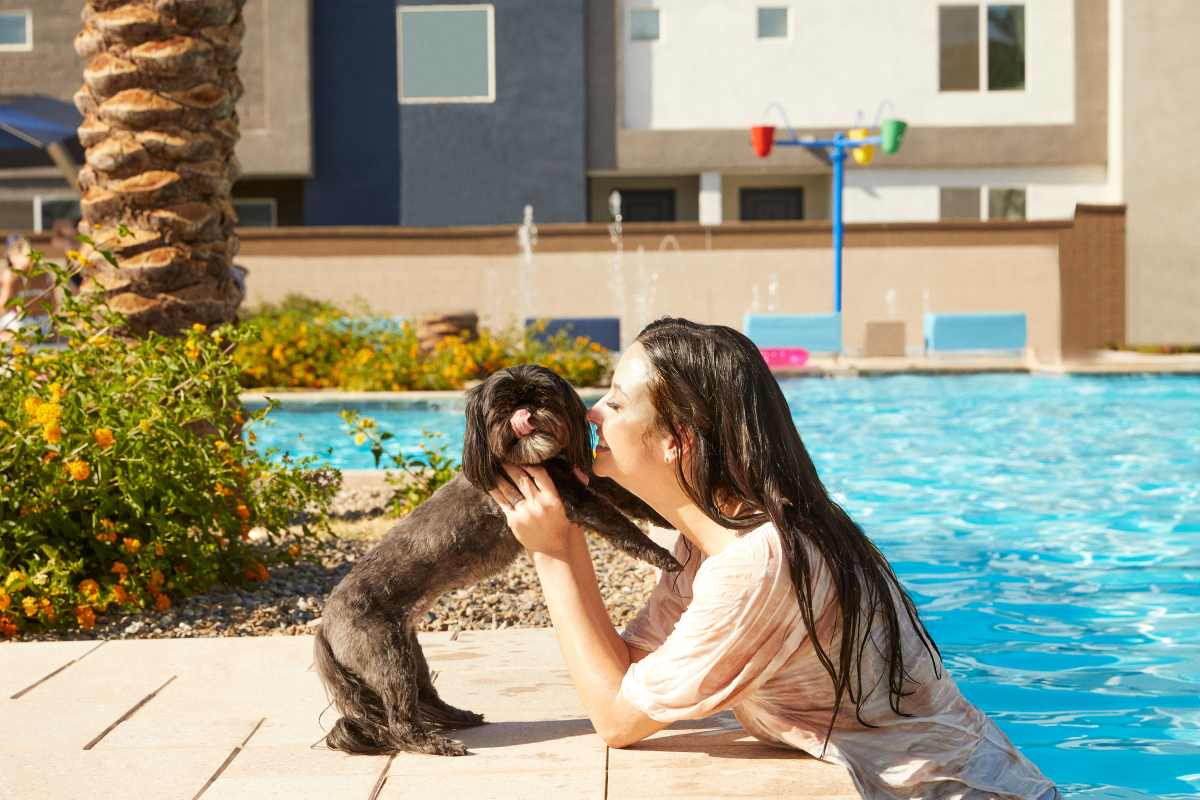 Resident and her pet at the pool area at  BB Living Wellen Park in Venice, Florida