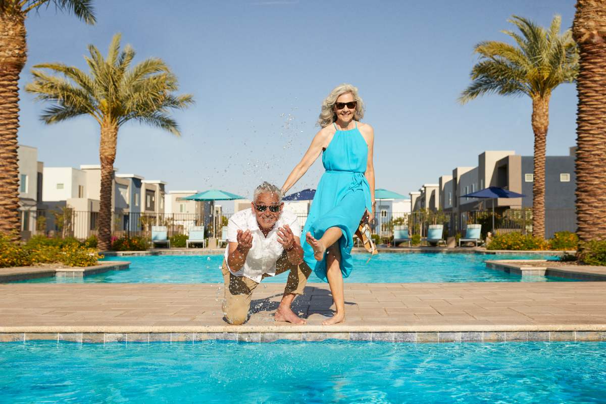 Couple posing to camera near swimming pool at BB Living Wellen Park in Venice, Florida