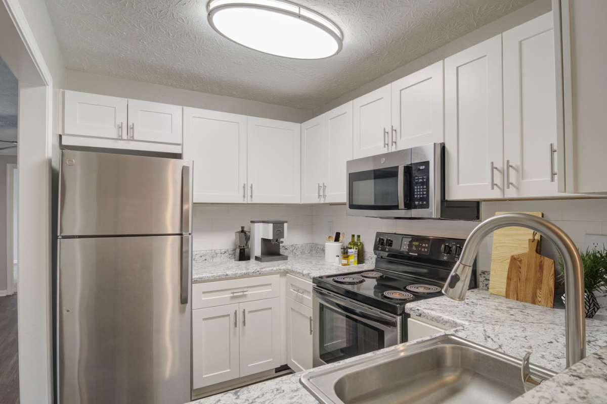 Stainless-steel appliances in an apartment kitchen at Place at Midway in Douglasville, Georgia