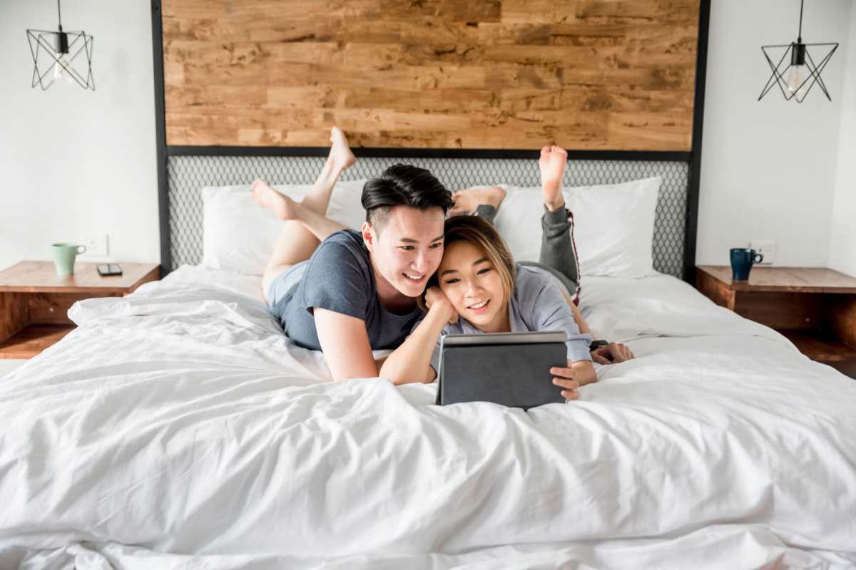 Happy couple in bedroom at Mamook Tokatee in Portland, Oregon