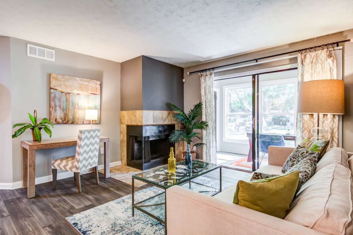 Living room with a fireplace at 2200 Big Creek Apartments in Roswell, Georgia