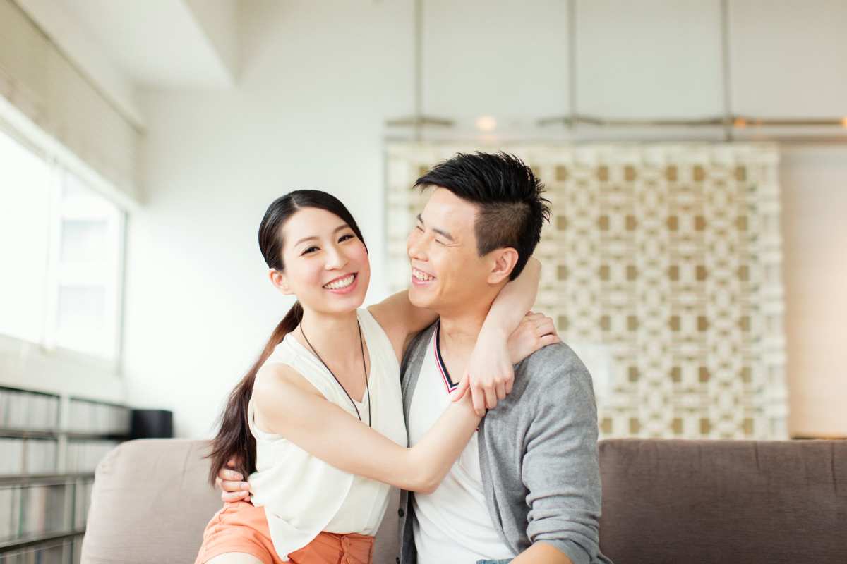 Couple sitting in living room filled with natural light at Hayu Tilixam in Portland, Oregon