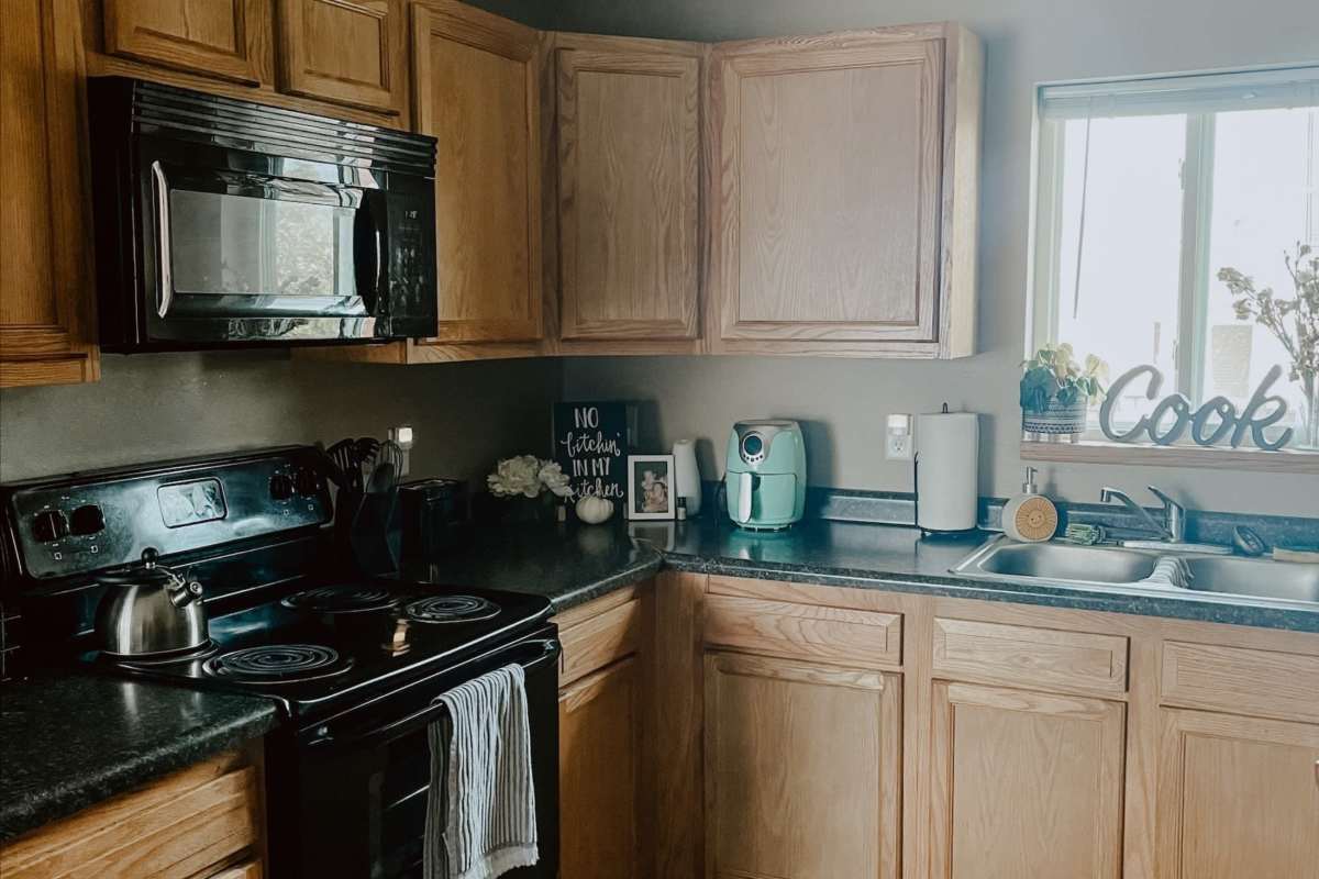 Apartment kitchen with oven and microwave at College Town Mankato in Mankato, Minnesota