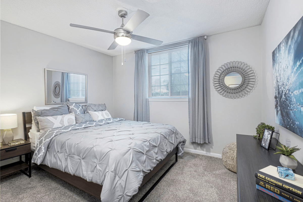 Cozy bedroom with a ceiling fan at Springdale Glen in Clarkston, Georgia