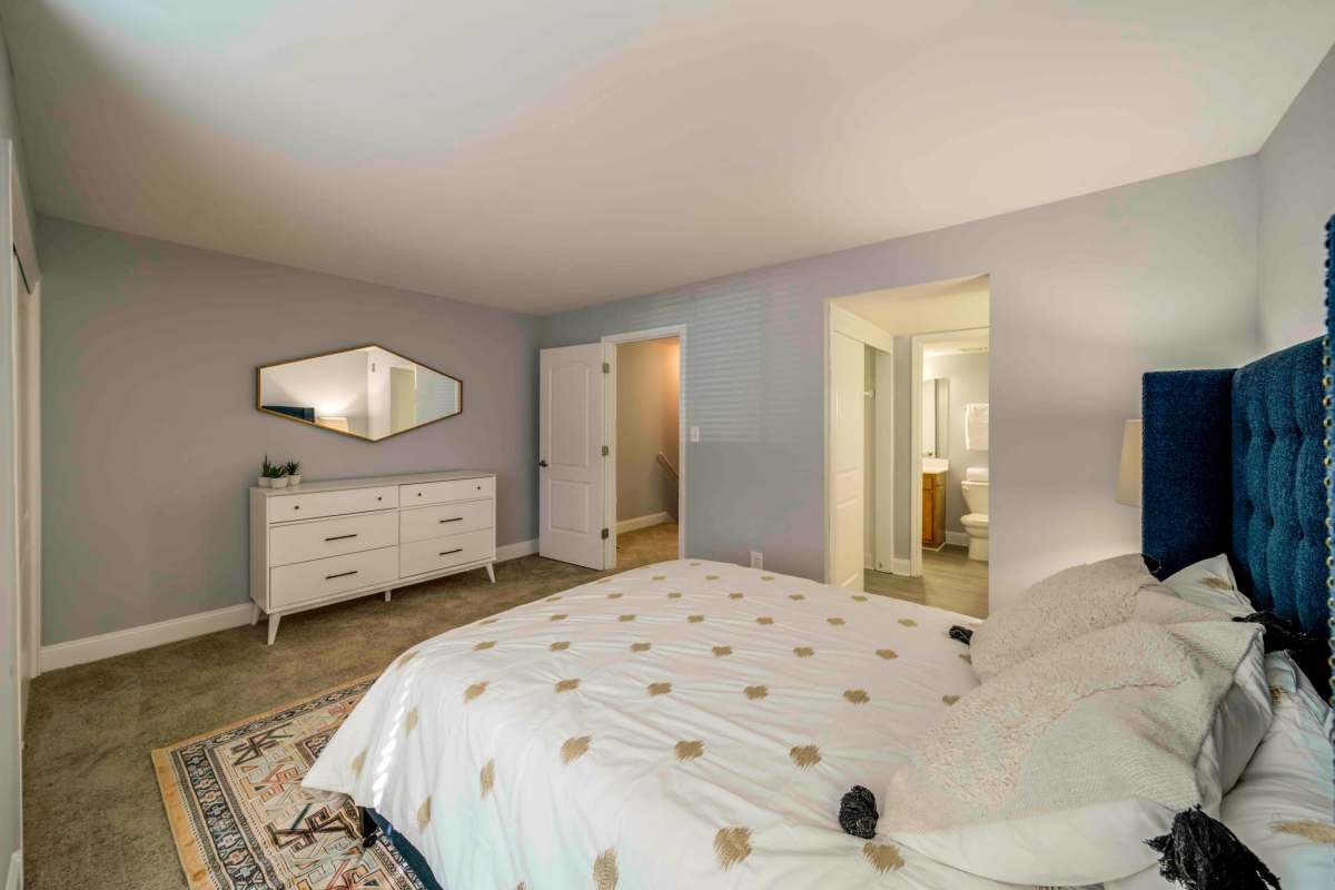 Bedroom with a walk-in closet at The Trails of North Hills in Raleigh, North Carolina