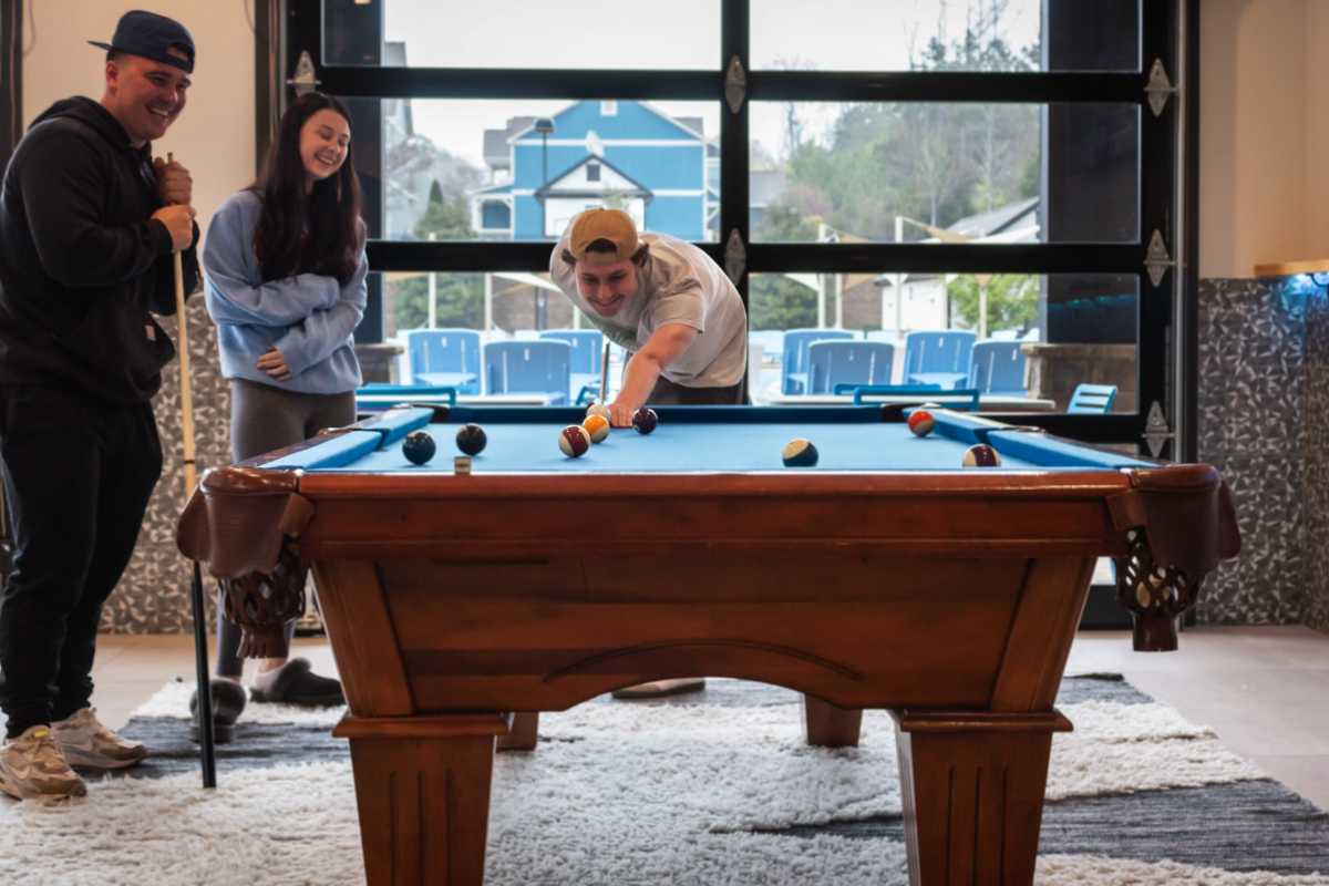 Friends shooting pool at College Town Oxford in Oxford, Mississippi