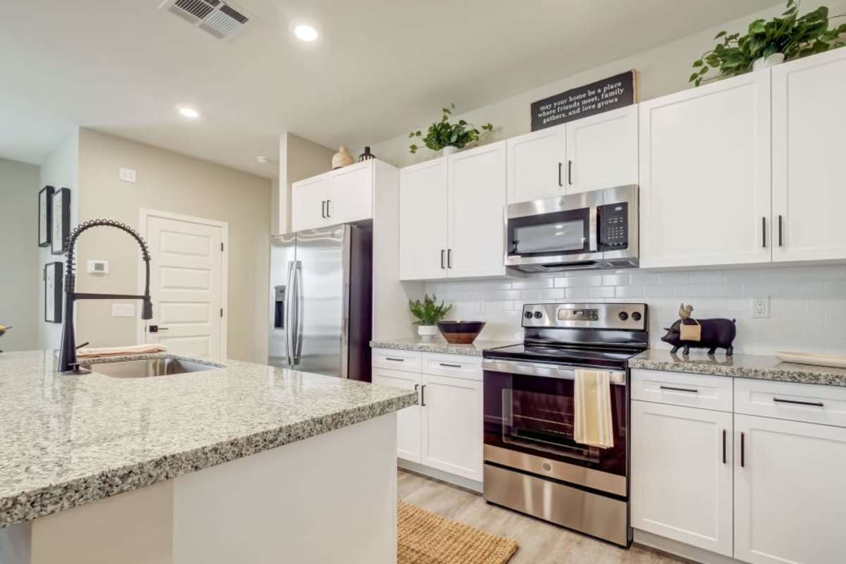 Apartment kitchen with white cabinets at BB Living at Trails Edge in Centennial, Colorado