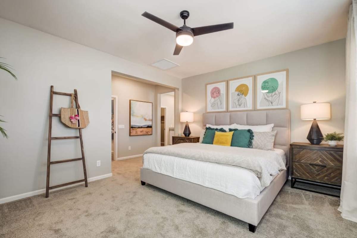 Carpeted apartment bedroom with ceiling fan at BB Living at The Oaks in Meridian, Idaho