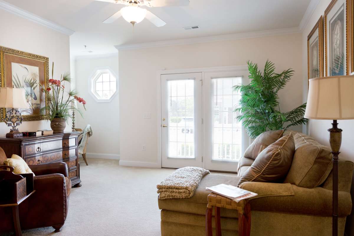 A furnished living room with doors to the balcony at Cloisters at Carolina Forest in Myrtle Beach, South Carolina