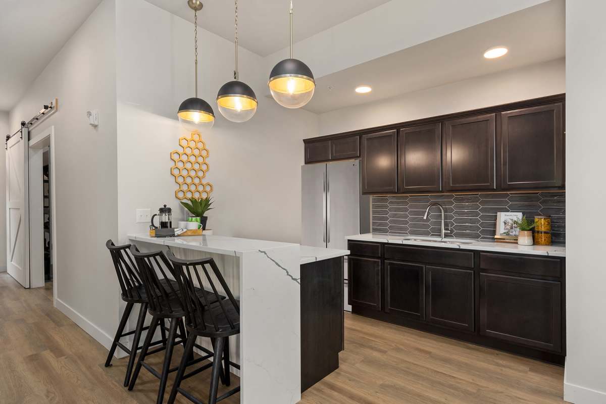 Our community kitchen with a counter seating at Alder Walk in Puyallup, Washington