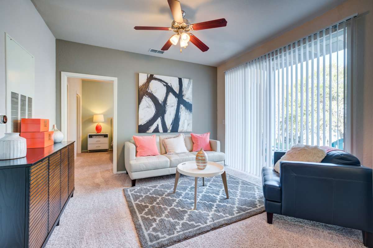 Resident large living space with wood-style flooring at Vista Lake Ned in Winter Haven, Florida